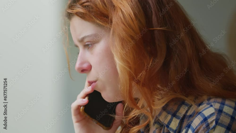 Redhead woman talking on phone, close up view Redhead woman talking on phone, close up view