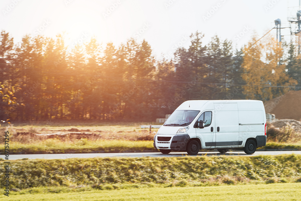Fast-Moving White Delivery Van on Urban Highway. Distribution and Logistics in Action. Modern Delivery Van on the Road. Shipping and distribution concept. Fast-Moving White Delivery Van on Urban Highway. Distribution and Logistics in Action. Modern Delivery Van on the Road. Shipping and distribution concept.