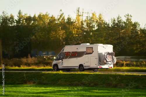 RV motorhome camper van on the highway with bike rack. Travel vacation adventure. Tourists in rental campervan. Tourism in motorhome