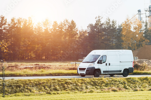 Wallpaper Mural Fast-Moving White Delivery Van on Urban Highway. Distribution and Logistics in Action. Modern Delivery Van on the Road. Shipping and distribution concept. Torontodigital.ca