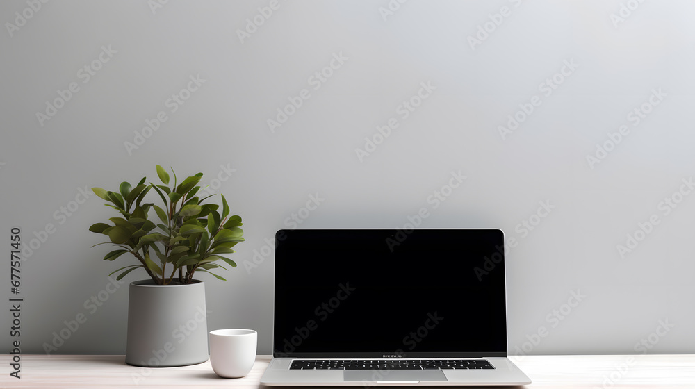Laptop computer with blank screen on desk in modern home or office interior mock up