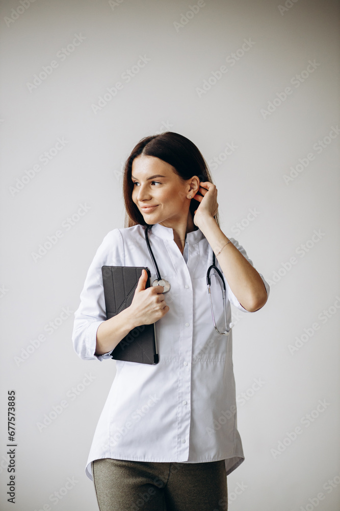 Young woman doctor in lab coat with stethoscope Young woman doctor in lab coat with stethoscope