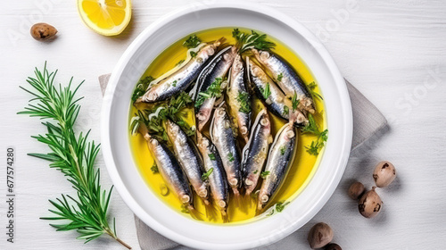 Fototapeta Naklejka Na Ścianę i Meble -  Anchovies marinated in olive oil and cooked at low temperature on a white plate.
