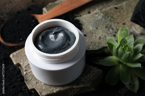 Natural cosmetics with charcoal on a dark background. © Atlas