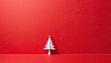Cute small abstract white christmas tree on red background with copy space