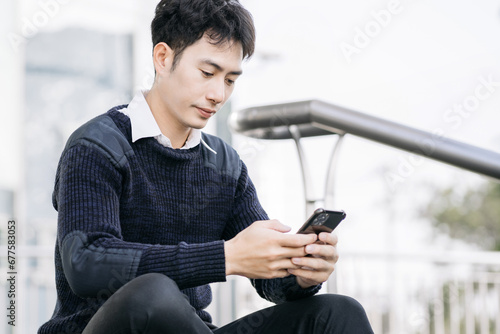 Businessman using mobile phone play social.
