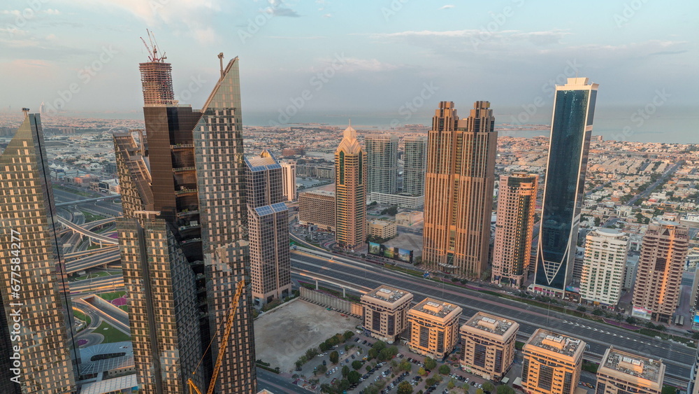 Obraz premium High-rise buildings on Sheikh Zayed Road in Dubai aerial morning timelapse, UAE.