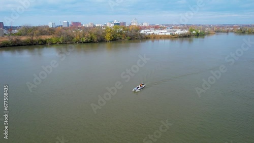 Fisherman in boat from drone wilmington delaware christina river warm fall day  photo