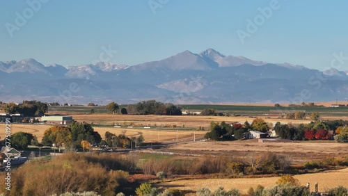 Longs peak colorado fourteen thousand feet mountain towering above the surrounding farms and fields.