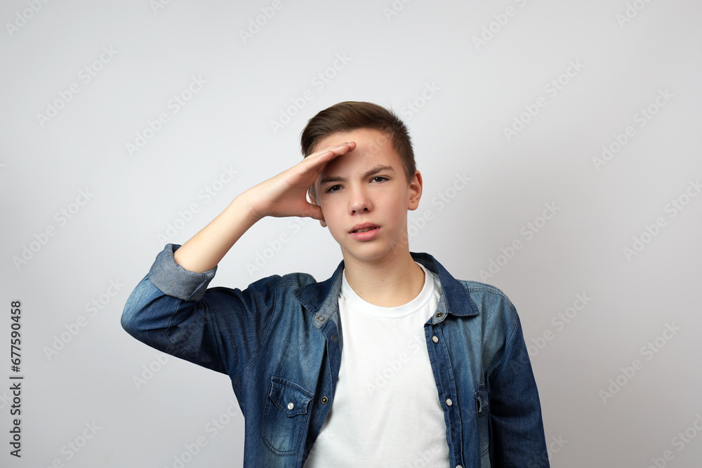 Teenage boy holding hands on his forehead and looking far away to the future, Teenage boy holding hands on his forehead and looking far away to the future,
