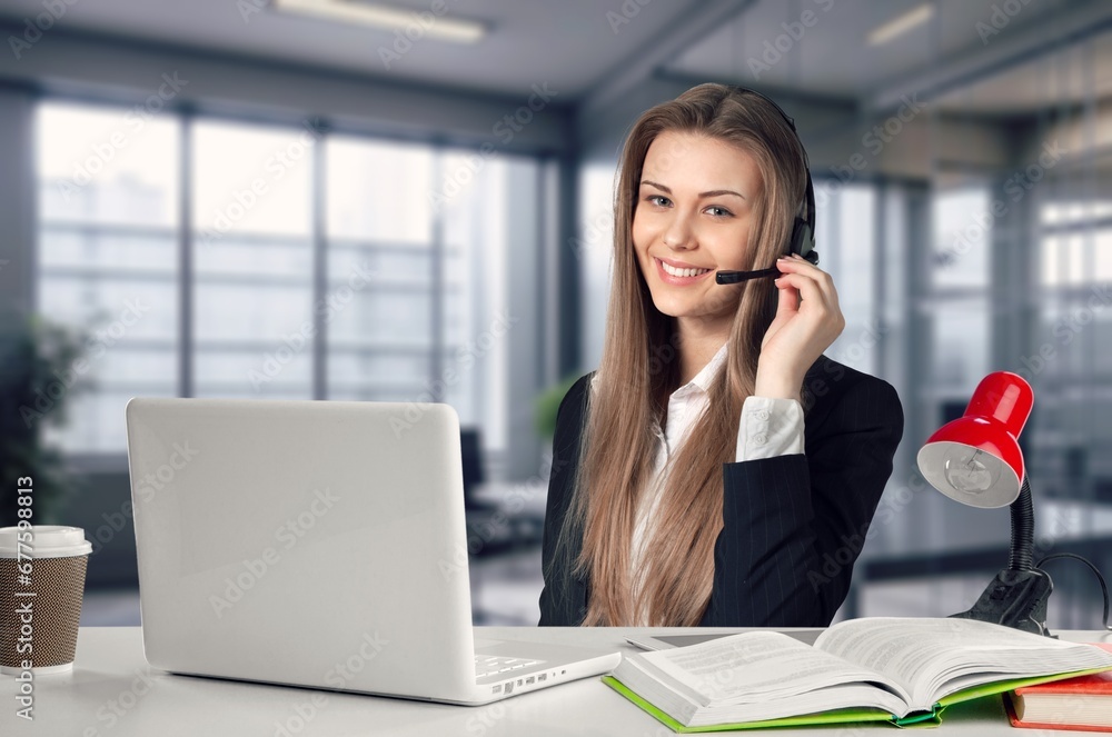 Portrait of business woman, using headset for online communication Portrait of business woman, using headset for online communication