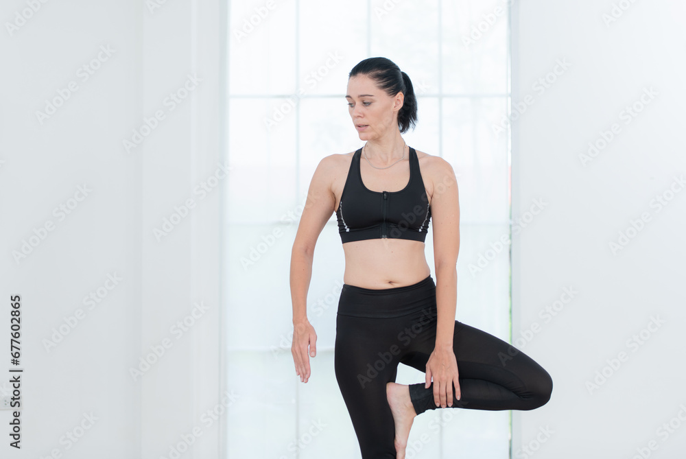 Beautiful young woman practicing yoga at home. Yoga asana. Beautiful young woman practicing yoga at home. Yoga asana.