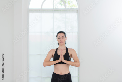Beautiful young woman practicing yoga at home. Yoga asana.