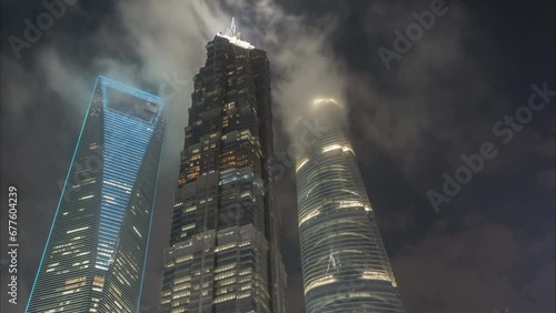 Night time lapse of clouds moving over the three most famous skyscrapers of Shanghai, skyline urban China
 photo