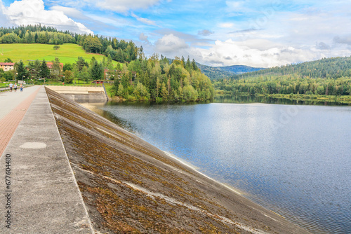An earthen dam on the Vistula river forming Czerniańskie Lake in the Czarne district in the tourist town - Wisła in the Silesian Beskids (Poland). photo