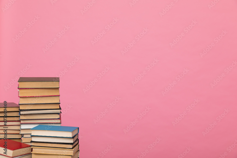 stack of books on a pink background in the learning library stack of books on a pink background in the learning library