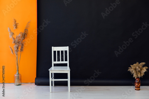 white chair on black background decorative flowers interior in the room photo