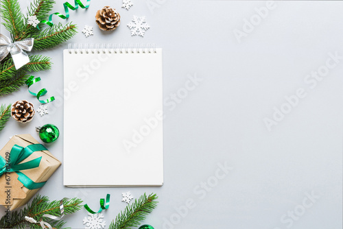 Christmas blank greeting card mock-up scene. Creative layout made of Christmas tree branches and paper card note. Flat lay. Nature New Year concept photo