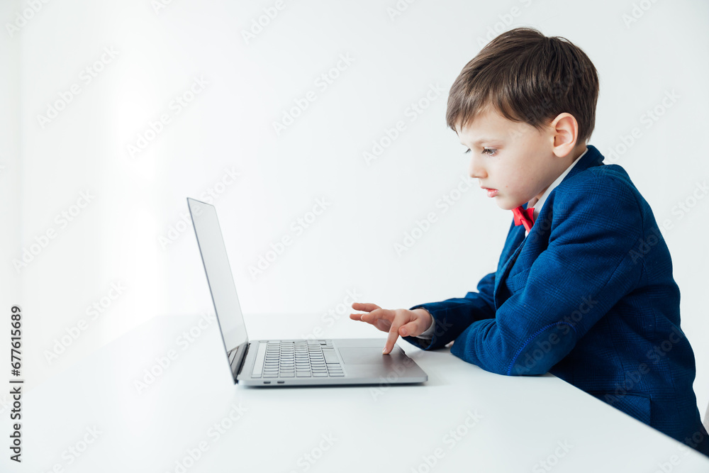 school IT programming boy at the computer in the classroom learning online school IT programming boy at the computer in the classroom learning online