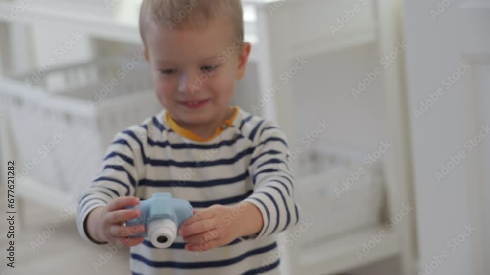 toddler child little boy with toy camera taking pictures at home toddler child little boy with toy camera taking pictures at home