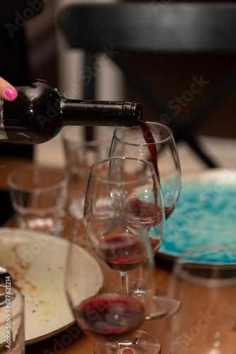 Sommelier pours red wine into a glass during tasting