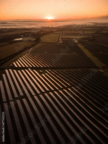 Drone aerial view of a solar farm at sunrise