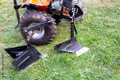 Plow and hiller complete with a walk-behind tractor for agricultural work. photo