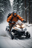A man wearing an orange jacket, protective helmet and goggles on a snowmobile in winter in the forest