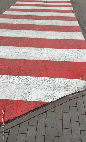 Red and white zebra on the street. Crosswalk. 