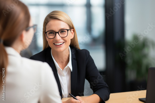 Fototapeta Naklejka Na Ścianę i Meble -  Happy mid aged business woman manager at office meeting. Smiling female hr hiring recruit at job interview, bank or insurance agent, lawyer making contract deal with client at work. 