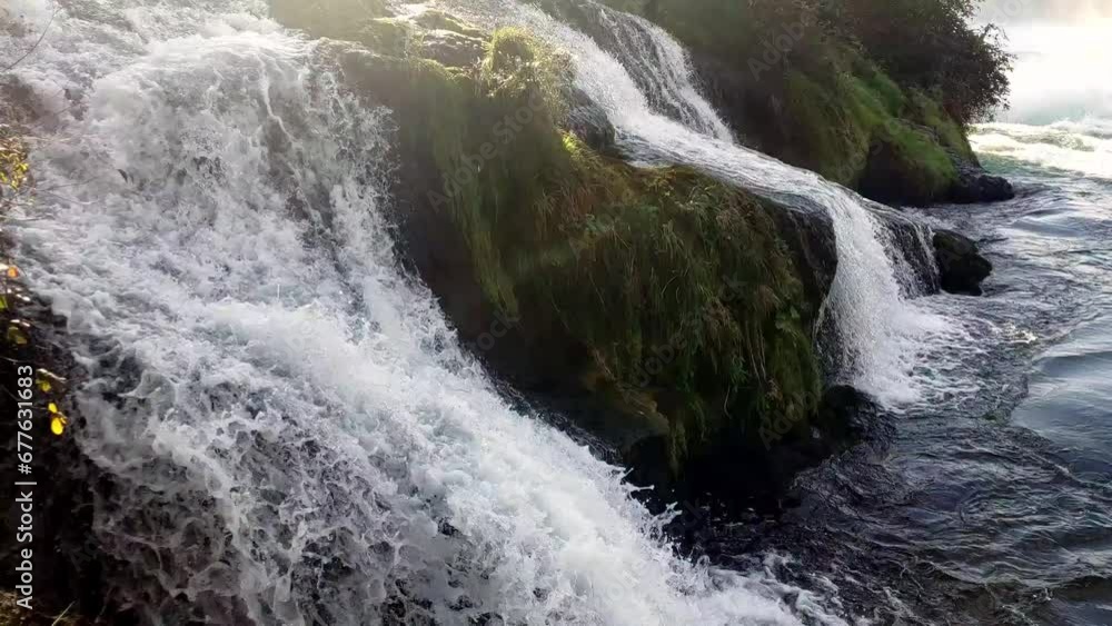 Waterfall and drops scatter on Rhine Falls in Switzerland. 4K Waterfall and drops scatter on Rhine Falls in Switzerland. 4K