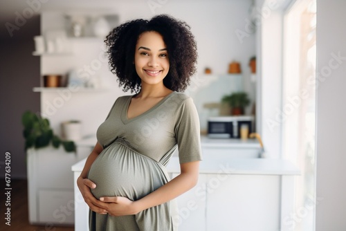 african american young pregnant woman relaxing at home photo