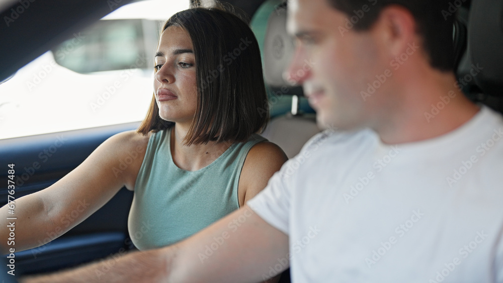 Beautiful couple smiling confident driving car at street