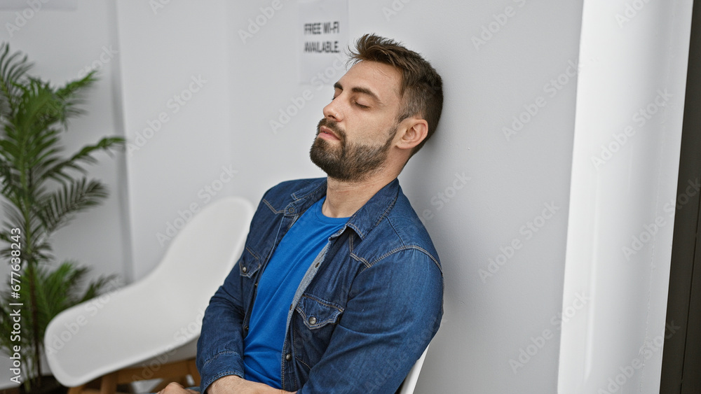 Young hispanic man sitting on chair sleeping at waiting room Young hispanic man sitting on chair sleeping at waiting room