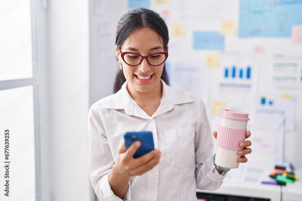 Young beautiful hispanic woman business worker using smartphone drinking coffee at office Young beautiful hispanic woman business worker using smartphone drinking coffee at office