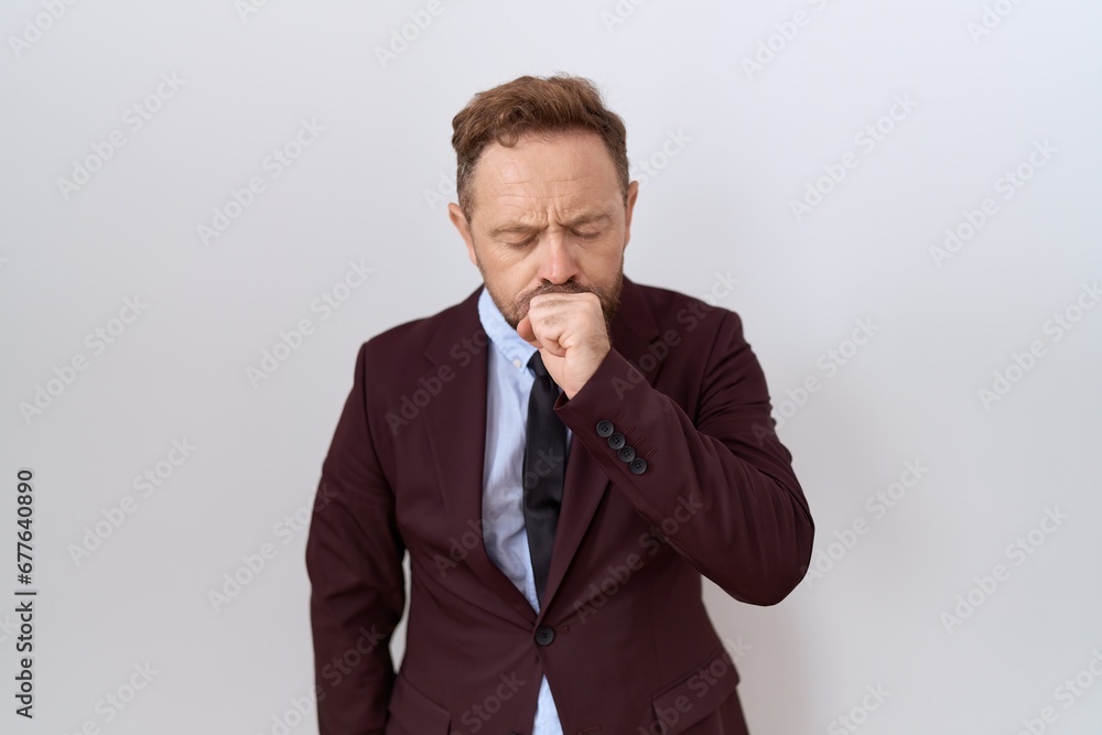 Middle age business man with beard wearing suit and tie feeling unwell and coughing as symptom for cold or bronchitis. health care concept. Middle age business man with beard wearing suit and tie feeling unwell and coughing as symptom for cold or bronchitis. health care concept.