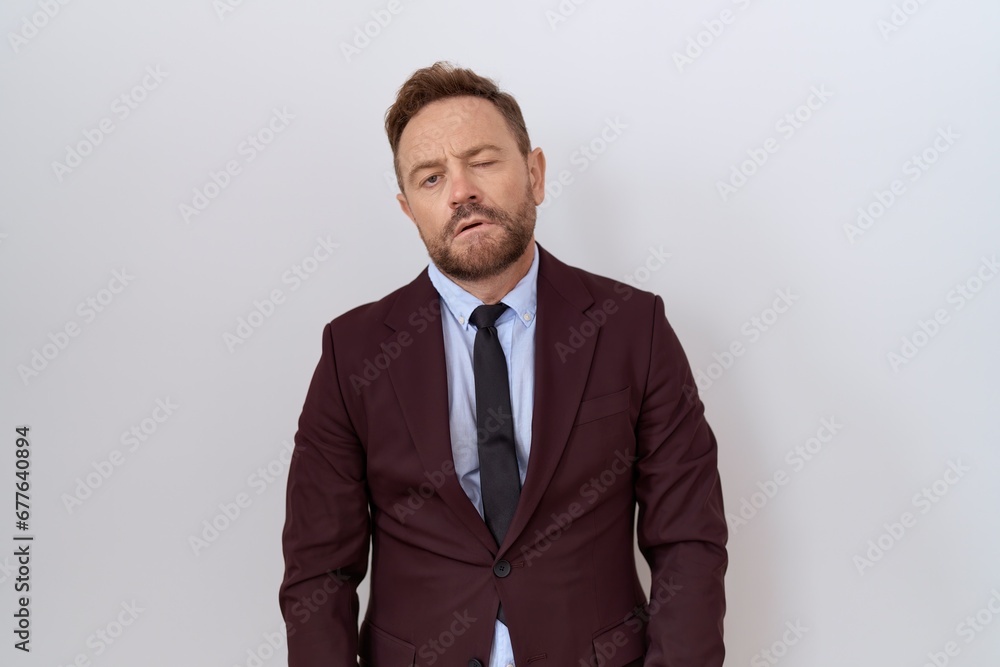 Middle age business man with beard wearing suit and tie looking sleepy and tired, exhausted for fatigue and hangover, lazy eyes in the morning. Middle age business man with beard wearing suit and tie looking sleepy and tired, exhausted for fatigue and hangover, lazy eyes in the morning.
