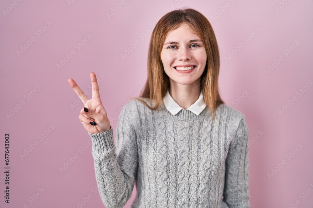 Beautiful woman standing over pink background showing and pointing up with fingers number two while smiling confident and happy. Beautiful woman standing over pink background showing and pointing up with fingers number two while smiling confident and happy.
