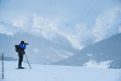 Man taking a photo in a snowfall