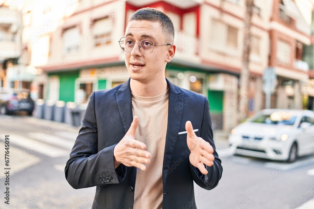Young hispanic man executive smiling confident speaking at street Young hispanic man executive smiling confident speaking at street
