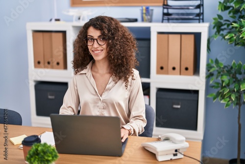 Young hispanic woman business worker using laptop working at office