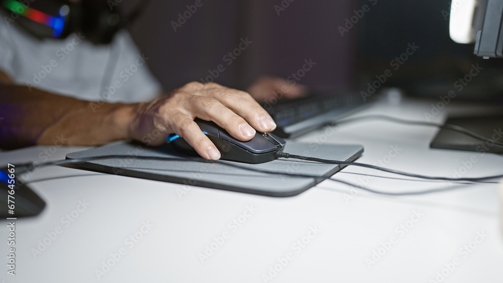 Middle age man diving into joy of gaming, playing video game with mouse in the heart of his gaming room, embracing an exciting, mature home entertainment night Middle age man diving into joy of gaming, playing video game with mouse in the heart of his gaming room, embracing an exciting, mature home entertainment night