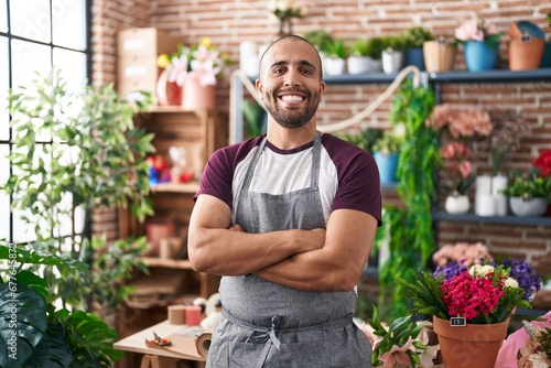 Young latin man florist smiling confident standing with arms crossed gesture at flower shop