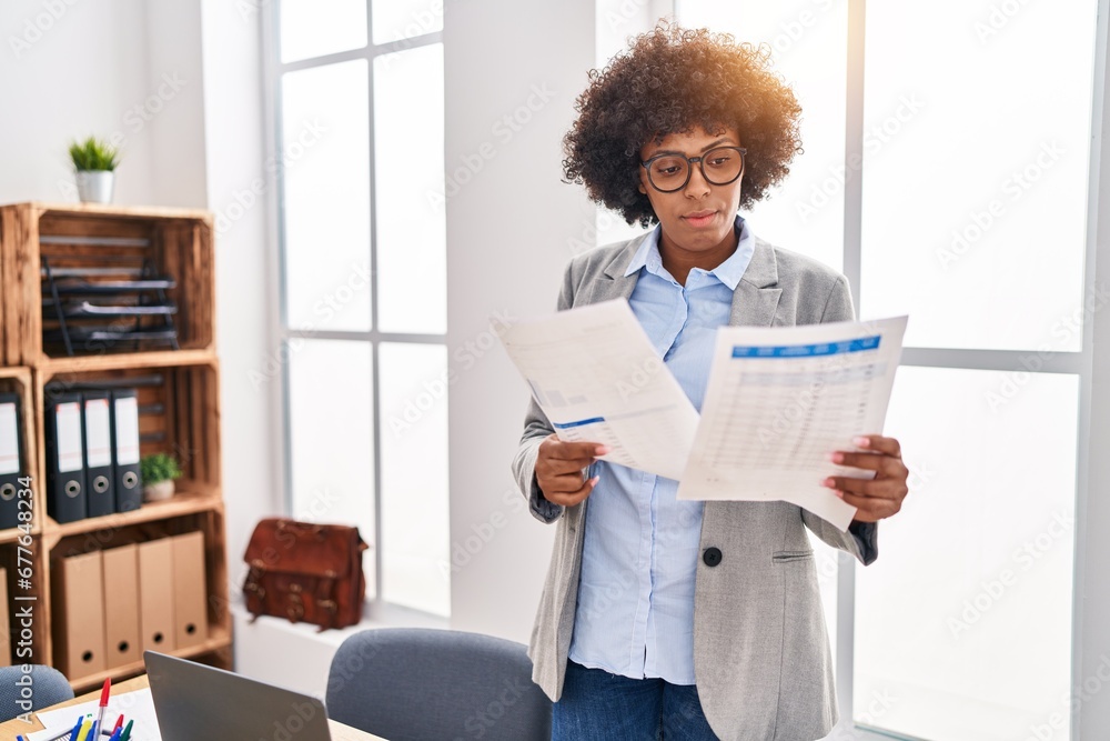 African american woman business worker reading document at office African american woman business worker reading document at office