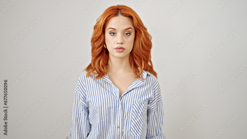 Young redhead woman standing with serious expression over isolated white background Young redhead woman standing with serious expression over isolated white background