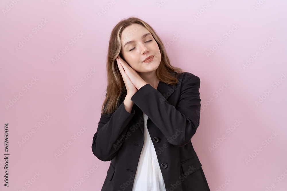 Young caucasian business woman wearing black jacket sleeping tired dreaming and posing with hands together while smiling with closed eyes. Young caucasian business woman wearing black jacket sleeping tired dreaming and posing with hands together while smiling with closed eyes.
