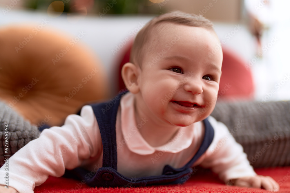 Adorable toddler smiling confident lying on sofa at home Adorable toddler smiling confident lying on sofa at home
