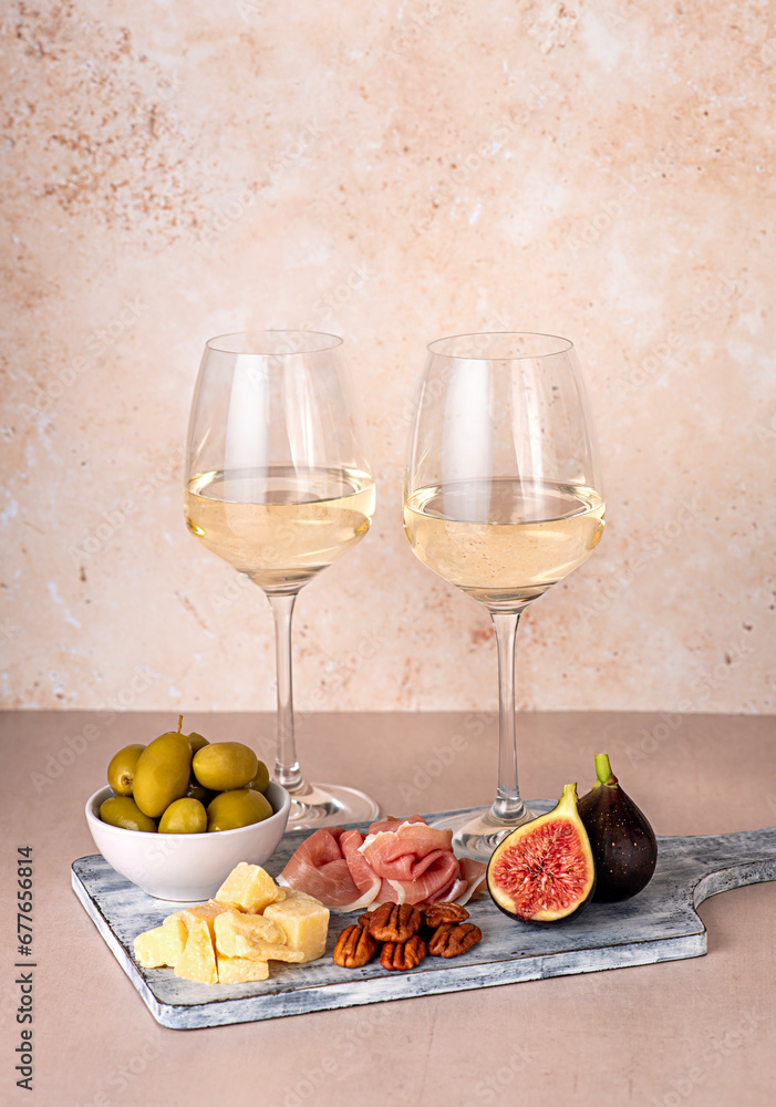 Food photography of white wine; cheese; parmesan; fig; prosciutto, pecan, olive, wineglass; bottle; chardonnay, sauvignon, winery Food photography of white wine; cheese; parmesan; fig; prosciutto, pecan, olive, wineglass; bottle; chardonnay, sauvignon, winery