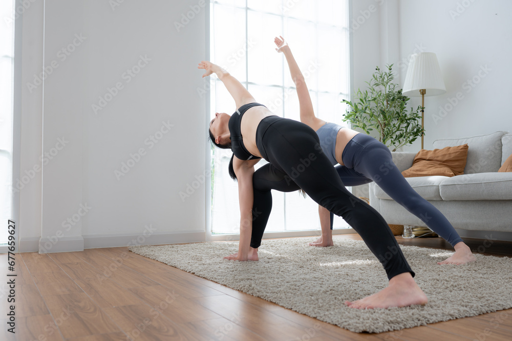 Young woman practicing yoga with instructor in house. Individual yoga class practicing in house Young woman practicing yoga with instructor in house. Individual yoga class practicing in house