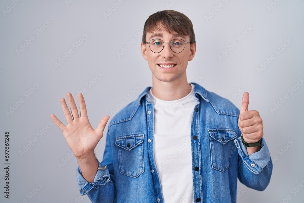 Caucasian blond man standing wearing glasses showing and pointing up with fingers number six while smiling confident and happy. Caucasian blond man standing wearing glasses showing and pointing up with fingers number six while smiling confident and happy.